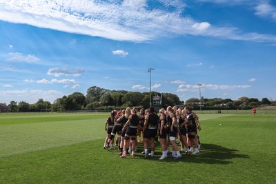 250825 - Wales Women Rugby World Cup Training Session - The Wales squad huddle up during a Wales training session ahead of their Women’s Rugby World Cup match against Canada