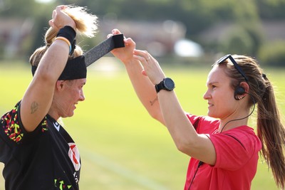 250825 - Wales Women Rugby World Cup Training Session - Kerin Lake is strapped up by Cara Jones, physio, during a Wales training session ahead of their Women’s Rugby World Cup match against Canada