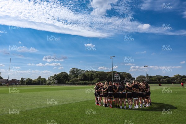 250825 - Wales Women Rugby World Cup Training Session - The Wales squad huddle up during a Wales training session ahead of their Women’s Rugby World Cup match against Canada