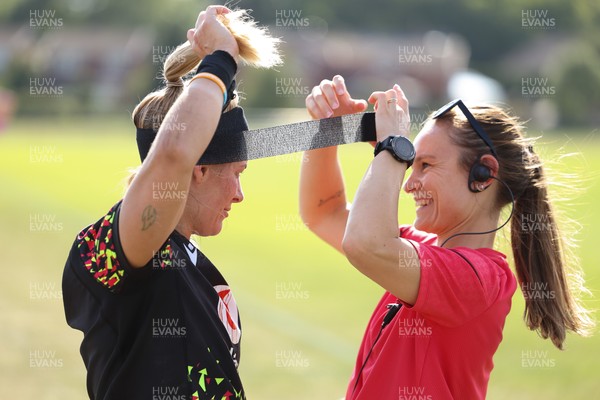 250825 - Wales Women Rugby World Cup Training Session - Kerin Lake is strapped up by Cara Jones, physio, during a Wales training session ahead of their Women’s Rugby World Cup match against Canada