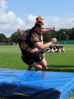 260825 - Wales Women Rugby World Cup Training Session - Molly Reardon tackles Gwenllian Pyrs during a Wales training session ahead of their Women’s Rugby World Cup match against Canada