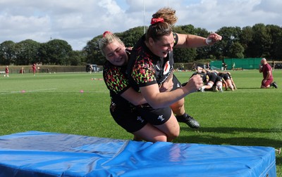 260825 - Wales Women Rugby World Cup Training Session - Molly Reardon tackles Gwenllian Pyrs during a Wales training session ahead of their Women’s Rugby World Cup match against Canada