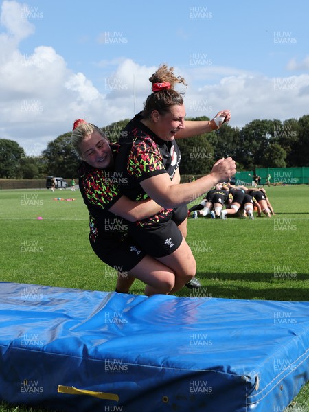 260825 - Wales Women Rugby World Cup Training Session - Molly Reardon tackles Gwenllian Pyrs during a Wales training session ahead of their Women’s Rugby World Cup match against Canada