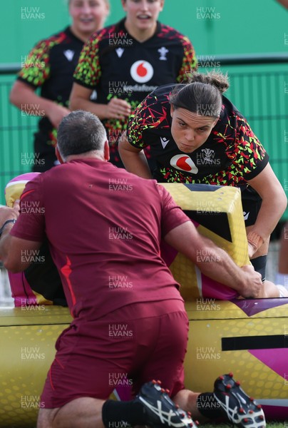 260825 - Wales Women Rugby World Cup Training Session - Shaun Connor, Wales Women attack coach takes a hit from Bryonie King during a Wales training session ahead of their Women’s Rugby World Cup match against Canada
