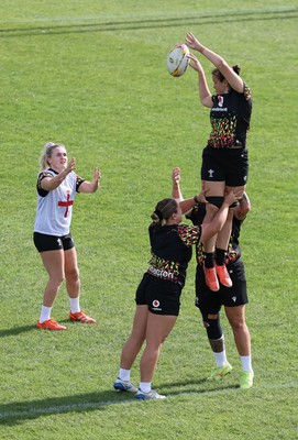 280825 - Wales Women Rugby World Cup Training Session - Branwen Metcalfe passes to Alex Callender during a Wales rugby training session ahead of their Women’s Rugby World Cup match against Canada