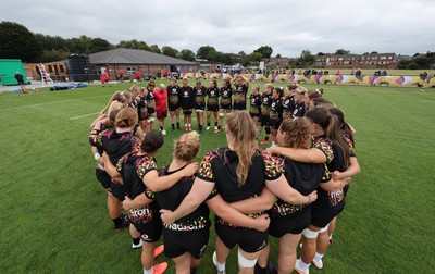 180825 - Wales Women Training Session - The team huddle up during a Wales Women training session ahead of their first Women’s Rugby World Cup match against Scotland