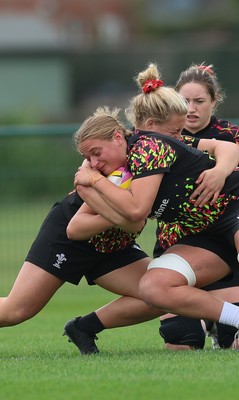 180825 - Wales Women Training Session - Tilly Vucaj is tackled by  Molly Reardon during a Wales Women training session ahead of their first Women’s Rugby World Cup match against Scotland