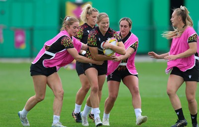 180825 - Wales Women Training Session - Carys Cox gets between Lisa Neumann and Courtney Keight during a Wales Women training session ahead of their first Women’s Rugby World Cup match against Scotland