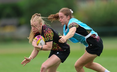 180825 - Wales Women Training Session - Cath Richards is held by Lisa Neumann during a Wales Women training session ahead of their first Women’s Rugby World Cup match against Scotland