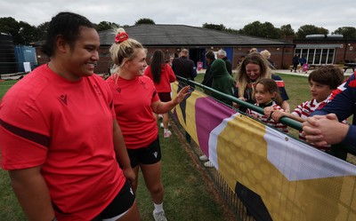 180825 - Wales Women Training Session - Wales’  Sisilia Tuipulotu and Alex Callendar with rugby fans who watched the Wales Women training session ahead of their first Women’s Rugby World Cup match against Scotland