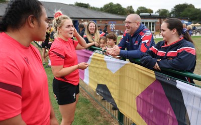 180825 - Wales Women Training Session - Wales’  Sisilia Tuipulotu and Alex Callendar with rugby fans who watched the Wales Women training session ahead of their first Women’s Rugby World Cup match against Scotland