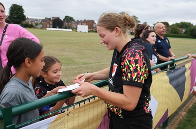 180825 - Wales Women Training Session - Wales’  Carys Cox with rugby fans who watched the Wales Women training session ahead of their first Women’s Rugby World Cup match against Scotland