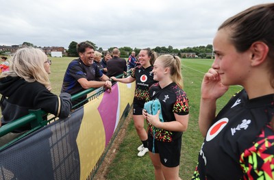 180825 - Wales Women Training Session - Wales’  Katherine Baverstock, Seren Lockwood  and Branwen Metcalfe with rugby fans who watched the Wales Women training session ahead of their first Women’s Rugby World Cup match against Scotland