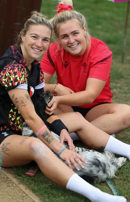 180825 - Wales Women Training Session - Keira Bevan and Alex Callendar, meet a four legged fan during a Wales Women training session ahead of their first Women’s Rugby World Cup match against Scotland