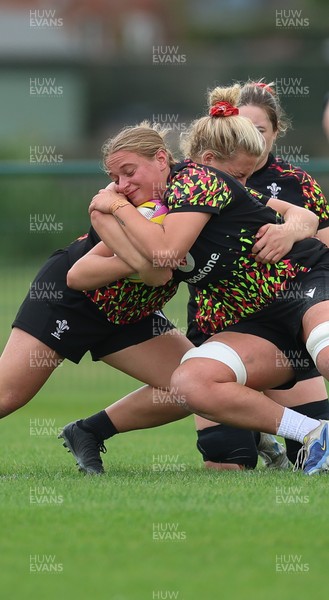 180825 - Wales Women Training Session - Tilly Vucaj is tackled by  Molly Reardon during a Wales Women training session ahead of their first Women’s Rugby World Cup match against Scotland