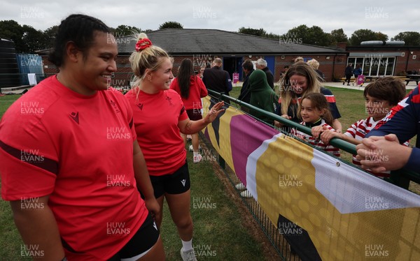 180825 - Wales Women Training Session - Wales’  Sisilia Tuipulotu and Alex Callendar with rugby fans who watched the Wales Women training session ahead of their first Women’s Rugby World Cup match against Scotland