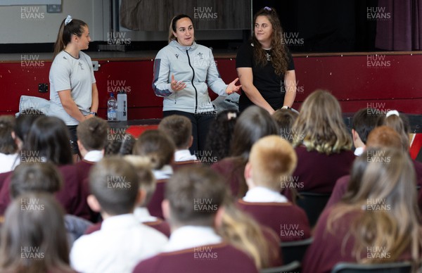 250923 - Wales Women School Visit - Wales Women squad members, left to right, Kayleigh Powell, Courtney Keight and Natalia John speak to pupils at Ysgol Dyffryn Conway, Llanrwst, during a question and answer session at the school