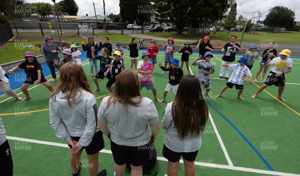 281022 - Wales Women Rugby School Engagement Event at Kamo Primary School - Wales team members Niamh Terr, Caryl Thomas and Kayleigh Powell are welcomed as they arrive at Kamo Primary School in Whangarei to meet the children and take part in rugby activities