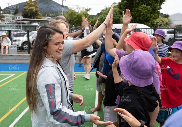 281022 - Wales Women Rugby School Engagement Event at Kamo Primary School - Wales team member Kayleigh Powell is welcomed  as she arrives at Kamo Primary School in Whangarei to meet the children and take part in rugby activities
