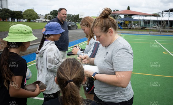 281022 - Wales Women Rugby School Engagement Event at Kamo Primary School - Wales’ Caryl Thomas and Niamh Terry sign autographs as they meet the children at Kamo Primary School in Whangarei during a visit to take part in rugby activities