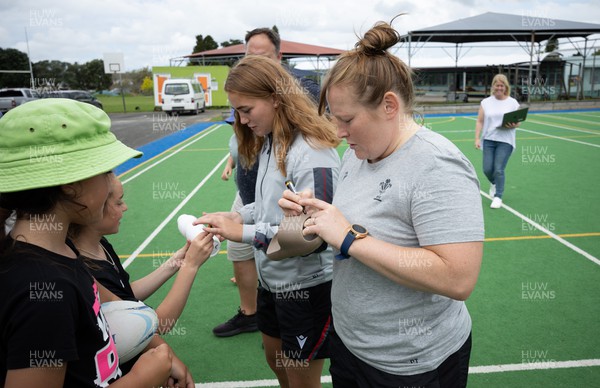 281022 - Wales Women Rugby School Engagement Event at Kamo Primary School - Wales’ Caryl Thomas and Niamh Terry sign autographs as they meet the children at Kamo Primary School in Whangarei during a visit to take part in rugby activities