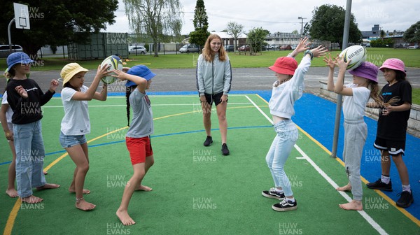 281022 - Wales Women Rugby School Engagement Event at Kamo Primary School - Wales’ Niamh Terry takes part in a rugby coaching session with children at Kamo Primary School in Whangarei during a visit to the school