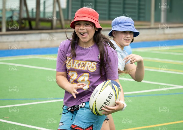 281022 - Wales Women Rugby School Engagement Event at Kamo Primary School - Children at Kamo Primary School in Whangarei take part in a rugby coaching session with Wales players during a visit to the school