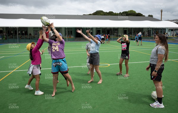 281022 - Wales Women Rugby School Engagement Event at Kamo Primary School - Wales’ Kayleigh Powell takes part in a riugby coaching session with children at Kamo Primary School in Whangarei during a visit to the school