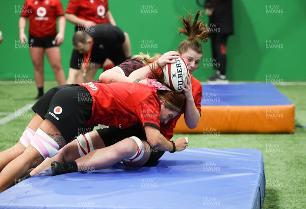 120324 - Wales Women skills session - Kate Williams is tackled during a skills session ahead of the start of the Women’s 6 Nations