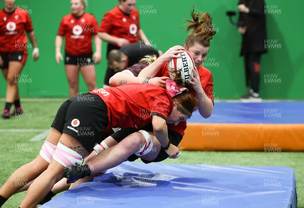 120324 - Wales Women skills session - Kate Williams is tackled during a skills session ahead of the start of the Women’s 6 Nations