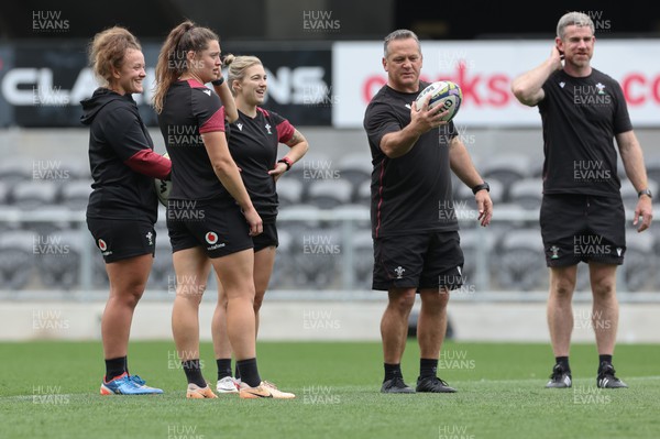 261023 - Wales’ Women Stadium Orientation and Kickers Session - Wales kickers Lleucu George, Robyn Wilkins and Keira Bevan with coaches Shaun Connor and Eifion Roberts during a kickers session at the Forsyth Barr Stadium in Dunedin where they will play New Zealand in WCV1 on Saturday