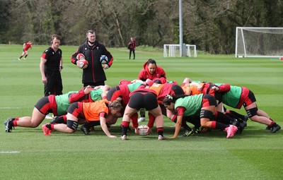 010421 - Wales Women Rugby Squad Training session - Assistant coach Sophie Spence works with the forwards along with Sam Dodge, strength and conditioning coach, left and Skills Coach Geraint Lewis during training session ahead of the start of the Women's Six Nations 