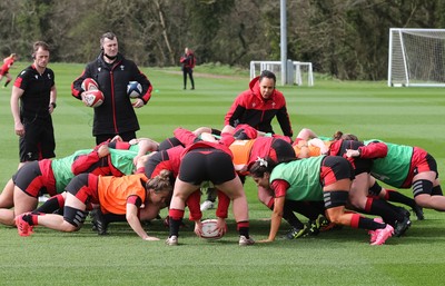 010421 - Wales Women Rugby Squad Training session - Assistant coach Sophie Spence works with the forwards along with Sam Dodge, strength and conditioning coach, left and Skills Coach Geraint Lewis during training session ahead of the start of the Women's Six Nations 