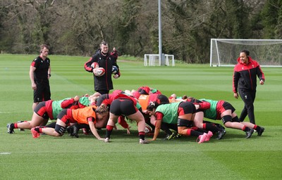 010421 - Wales Women Rugby Squad Training session - Assistant coach Sophie Spence works with the forwards along with Sam Dodge, strength and conditioning coach, left and Skills Coach Geraint Lewis during training session ahead of the start of the Women's Six Nations 