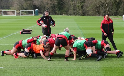 010421 - Wales Women Rugby Squad Training session - Assistant coach Sophie Spence works with the forwards along with Skills Coach Geraint Lewis during training session ahead of the start of the Women's Six Nations 