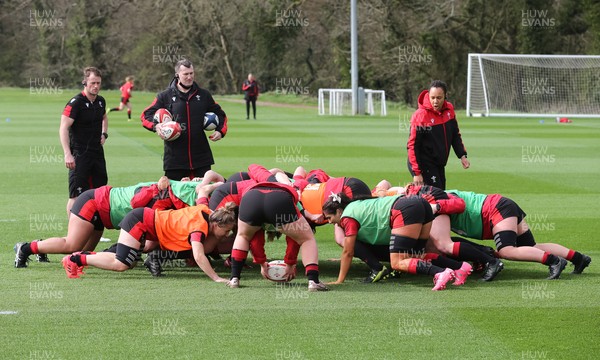 010421 - Wales Women Rugby Squad Training session - Assistant coach Sophie Spence works with the forwards along with Sam Dodge, strength and conditioning coach, left and Skills Coach Geraint Lewis during training session ahead of the start of the Women's Six Nations 