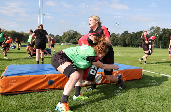 210922 - Wales Women RWC Training Session - Abbie Fleming of Wales tackles Alex Callender during a training session ahead of departure to New Zealand for the Rugby World Cup