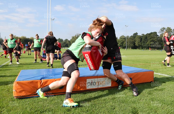 210922 - Wales Women RWC Training Session - Abbie Fleming of Wales tackles Alex Callender during a training session ahead of departure to New Zealand for the Rugby World Cup