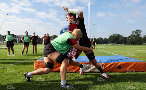 210922 - Wales Women RWC Training Session - Georgia Evans is tackled by Alisha Butchers during a training session ahead of departure to New Zealand for the Rugby World Cup