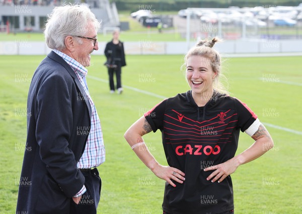 210922 - Wales Women RWC Training Session - WRU president Gerald Davies chats with Keira Bevan during a training session ahead of departure to New Zealand for the Rugby World Cup