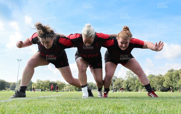 210922 - Wales Women RWC Training Session - Cerys Hale, Kelsey Jones and Cara Hope during a training session ahead of departure to New Zealand for the Rugby World Cup