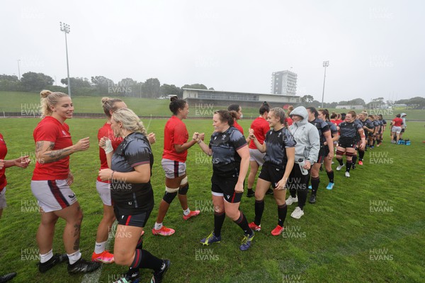 300922 - Wales Women Rugby Training Session - Wales and USA players gather together at the end of a combined training session with USA ahead of the start of the Women’s Rugby World Cup