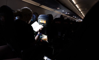 200325  Wales Women Rugby Squad travel to Edinburgh - Kelsey Jones reads on the flight from Bristol as Wales head to Edinburgh for the opening match of the Women’s 6 Nations against Scotland