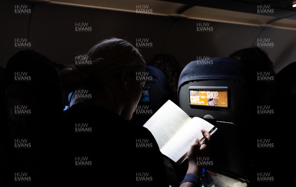 200325  Wales Women Rugby Squad travel to Edinburgh - Kelsey Jones reads on the flight from Bristol as Wales head to Edinburgh for the opening match of the Women’s 6 Nations against Scotland