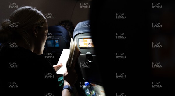 200325  Wales Women Rugby Squad travel to Edinburgh - Kelsey Jones reads on the flight from Bristol as Wales head to Edinburgh for the opening match of the Women’s 6 Nations against Scotland