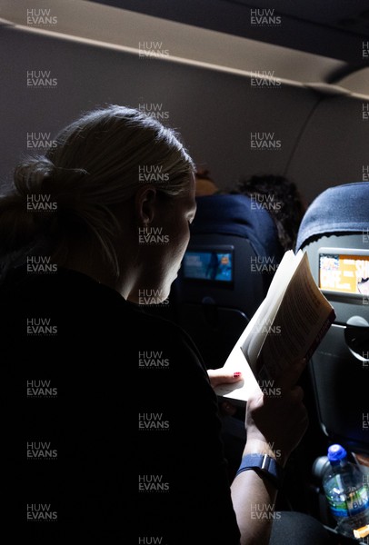 200325  Wales Women Rugby Squad travel to Edinburgh - Kelsey Jones reads on the flight from Bristol as Wales head to Edinburgh for the opening match of the Women’s 6 Nations against Scotland