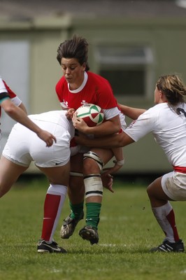 09.05.10 Wales v England - Womens' Under 20's - Wales' Sioned Harris is tackled by England's Poppy Cleall as Vicky Fleetwood moves in. 