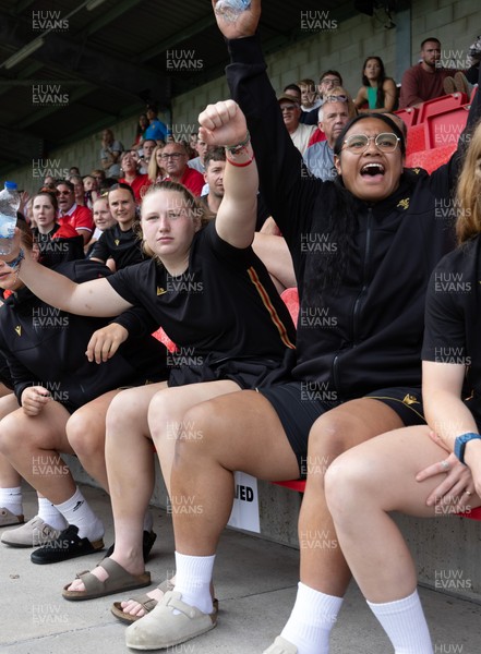 170725 - Wales Women U20 v Italy Women U20, Women’s U20 Six Nations Summer Series - Wales Women’s Senior Squad players celebrate as Wales U20s score The Squad stop off on their way to Australia to support the U20’s as they take on Italy Left to right Alaw Pyrs and Sisilia Tuipulotu