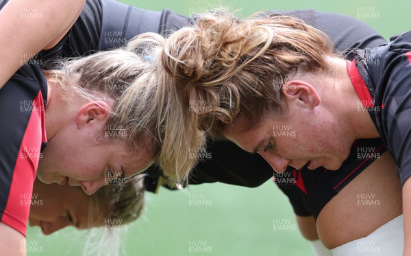 250822 - Wales Women Rugby Units Session - Wales’  Liliana Podpadec and Georgia Evans prepare to scrum against one another during a training session ahead of the match against Canada