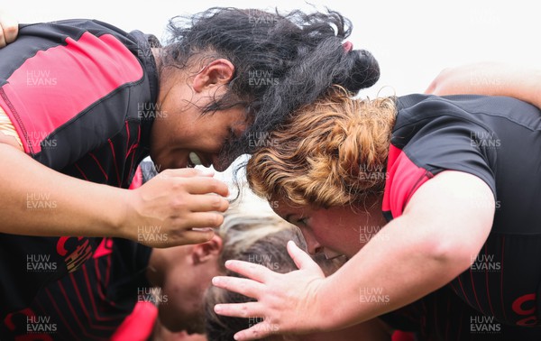 250822 - Wales Women Rugby Units Session - Wales’ Sisilia Tuipulotu and Cara Hope prepare to scrum against one another during a training session ahead of the match against Canada